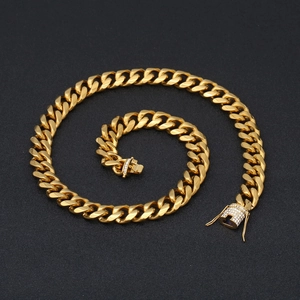 Macro detail of gold Cuban link chain with sparkling diamond-set box clasp for men