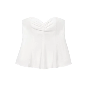 Detail of white linen blend tube top featuring pleated chest and flared hemline