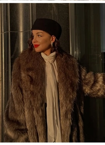 Detailed view of plush brown faux fur texture with silk scarf and classic beret accessory