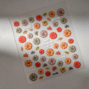Detailed view of 3D embossed Halloween pumpkin and maple leaf nail art stickers