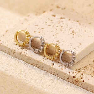 Detail view of gold and silver S925 sterling silver hoop earrings with small white pearls