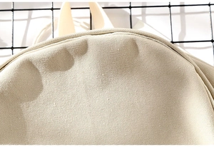 Close-up of durable cream canvas fabric texture showing high-density weaving detail