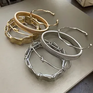 Set of four minimalist irregular metal open bracelets in gold and silver finishes