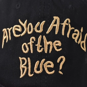 Washed distressed baseball cap in black with gold Are You Afraid of the Blue embroidery