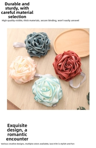 Close-up of soft mesh bath sponge flowers in various colors with fabric hanging loops