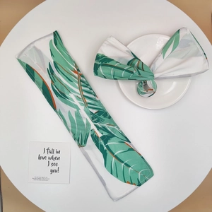 Detail of floral twist hair bun maker and ribbon set with tropical leaf patterns