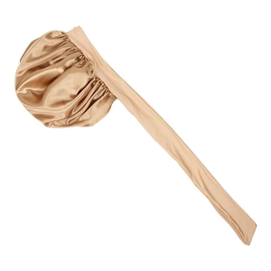 Detailed texture of champagne satin sleep bonnet with long ties and elastic band
