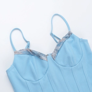 Detail of light blue lace corset top with boning structure and marble print neckline
