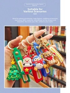 Set of four cartoon Christmas PVC keychains with festive characters and silicone wristlets