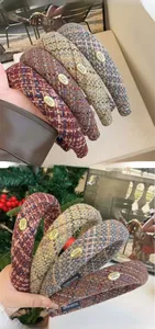 Detailed view of winter thick plaid fabric headbands with gold logo metal plate accents