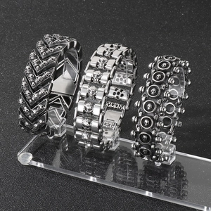 Detailed macro view of three vintage punk skull bracelets in black stainless steel
