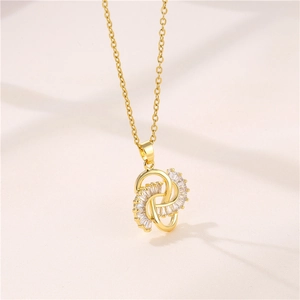 Golden Ruyi knot necklace with zircon stones on a soft beige fabric background