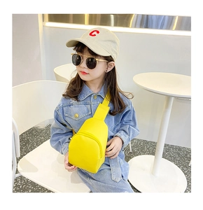 Detail of vibrant yellow PU leather crossbody chest bag for kids with adjustable strap