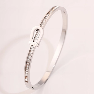 Detailed macro view of silver titanium steel bracelet with Love engraving and side crystals