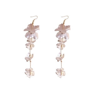 Elegant white pearlescent flower drop earrings with long gold tassels and floral layering