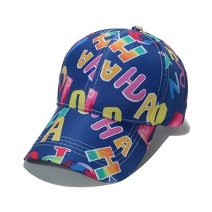 Detailed close-up of dark blue cotton baseball cap with colorful gradient ALOHA letters