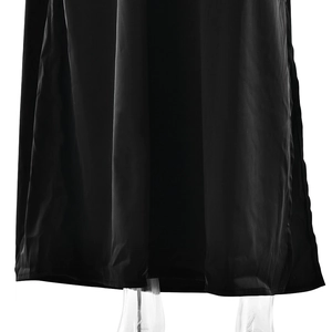 Detailed view of black satin fabric with elegant high slit and smooth draped texture