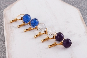 Detailed shot of multi-colored faceted crystal drop earrings with golden hooks