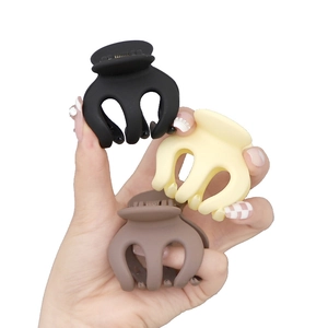 Three matte pumpkin claw clips in black, cream, and brown for high ponytail styling