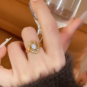 Detail of 24K gold-plated floral hollow ring with sparkling zircon inlays on hand