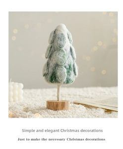 Detail of wool felt Christmas tree with snow top on wooden base for festive table decor