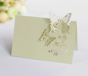 Macro shot of laser-cut 3D butterfly wedding place card in light green paper