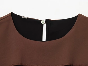 Detailed close-up of dark brown satin neckline with shell button and black lining