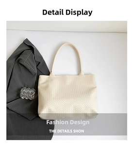 Detail of off-white woven tote bag with premium leather texture and minimalist design