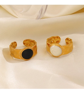 Detail of 18K gold plated hammered texture rings with black and white enamel on silk