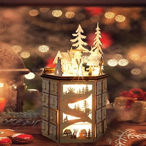 Detail of wooden LED Advent calendar with 24 drawers and laser-cut winter forest scene
