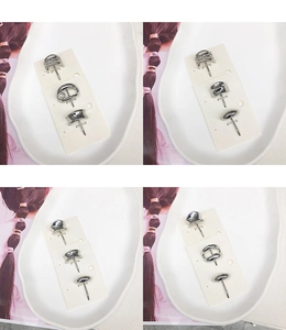 Detailed view of silver alloy stud earring set with pearl accents on a display card