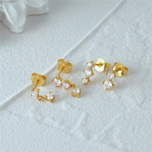 Macro shot of 925 silver gold plated earrings set with sparkling zircon stones