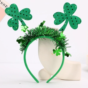Detailed view of St. Patrick's Day headband with green shamrocks and glitter tinsel