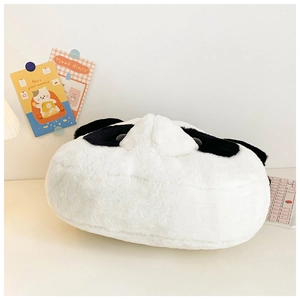 Close-up of fluffy panda plush bag on a desk with a pink keyboard and deco cards