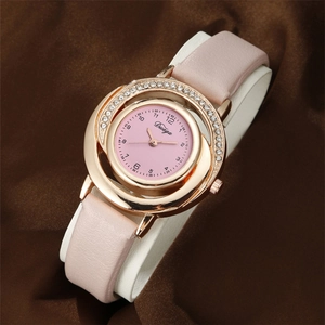 Close-up of pink dial women's watch with rhinestone bezel and rose gold case on silk