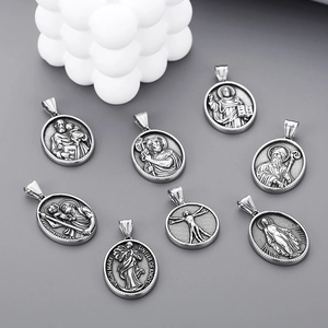 Macro detail of assorted vintage Saint Christopher and Virgin Mary stainless steel pendants
