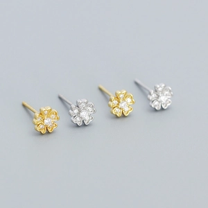 Detailed macro view of S925 sterling silver flower stud earrings with zircon micro-pave