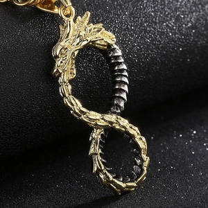 Detailed close-up of a dual-tone infinity dragon pendant in gold and black stainless steel