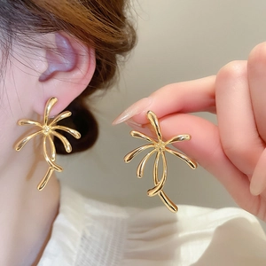 Macro shot of 18k gold plated petal earrings with radiant curved metal lines