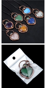 Macro detail of heart-shaped tiger eye stone pendant with antique bronze trim and cord