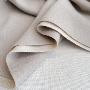 Macro shot of beige double-sided scarf with delicate herringbone weave texture