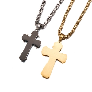 Detailed view of black and gold stainless steel cross pendants with thick Byzantine chains