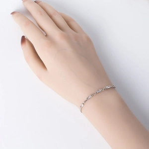 Detail view of s925 silver bracelet with rectangular zircons on woman's wrist