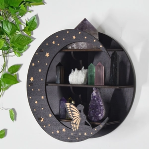 Detail of black three-tier crescent moon shelf with hollow star and butterfly patterns