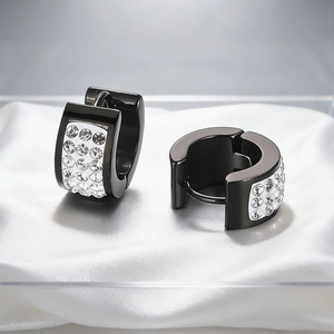 Macro shot of black plated earrings with three rows of sparkling crystal rhinestones