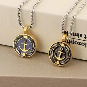 Detail of nautical compass and anchor pendants with blue and black enamel in gold finish