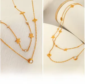 Macro view of gold-plated double-layer necklace with stars and floral pendants
