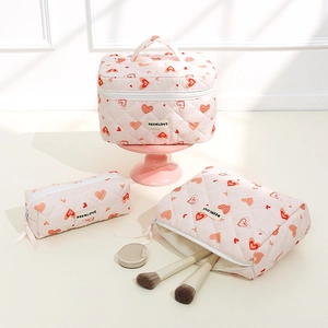 Set of three pink heart quilted makeup bags with large vanity case and small pouches