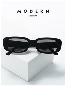 Detail of vintage square black sunglasses on minimalist white geometric display