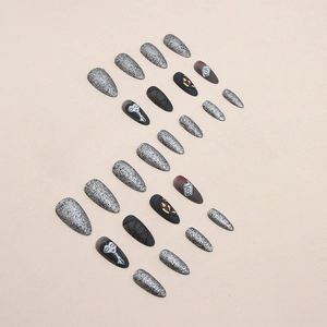 Gothic stiletto press-on nails featuring black matte spider web and silver glitter designs